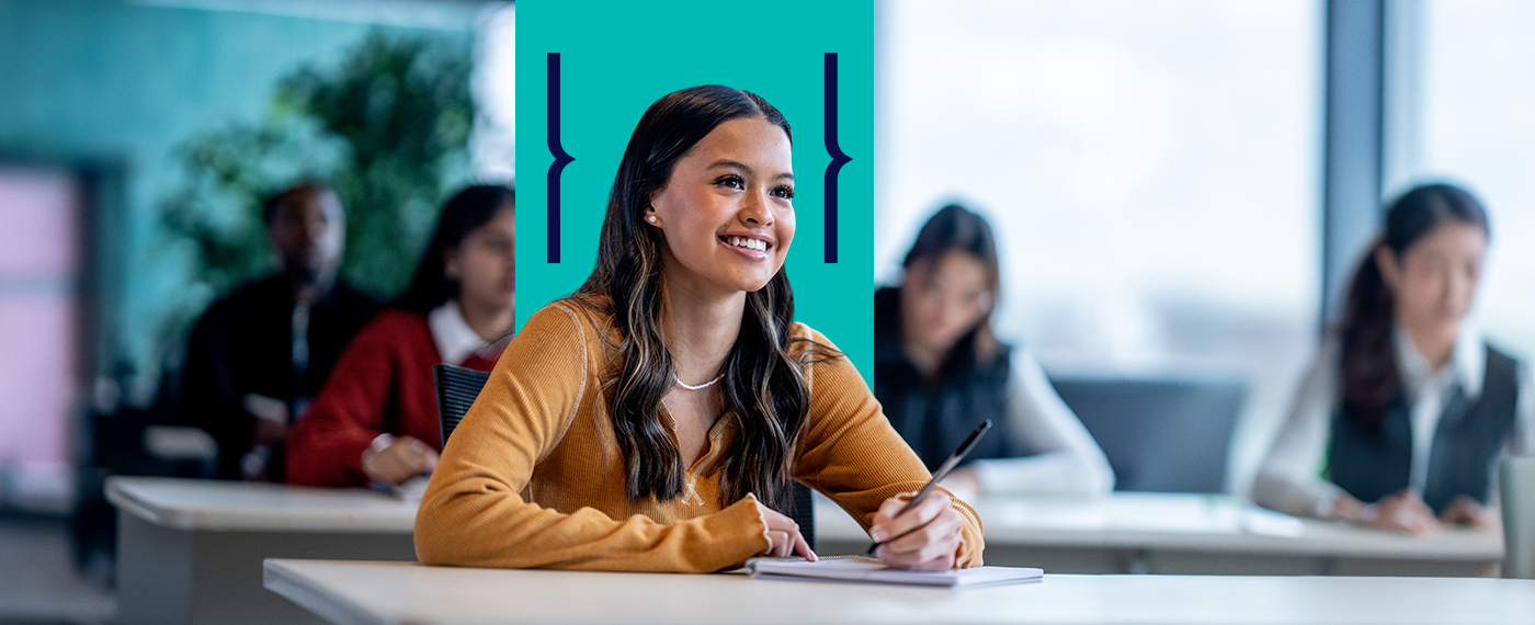 Student in classroom smiling as she is being taught