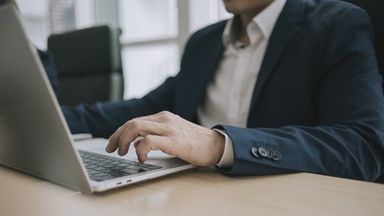 Man-typing-on-laptop-in-office