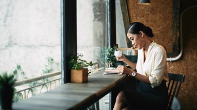 Woman-taking-notes-having-coffee