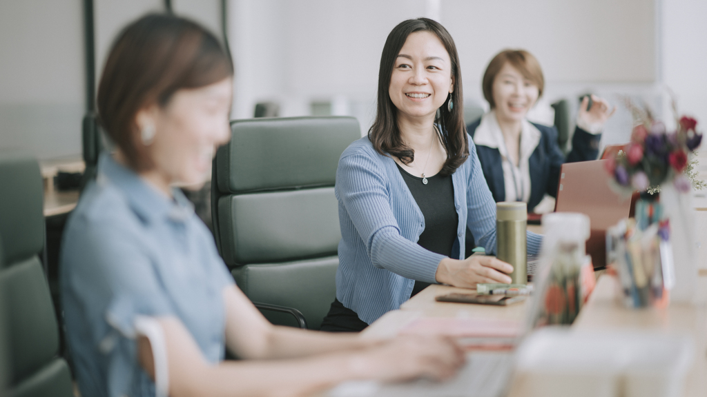 smiling-asian-woman-with-colleagues