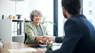 Woman-shaking-hands-in-meeting