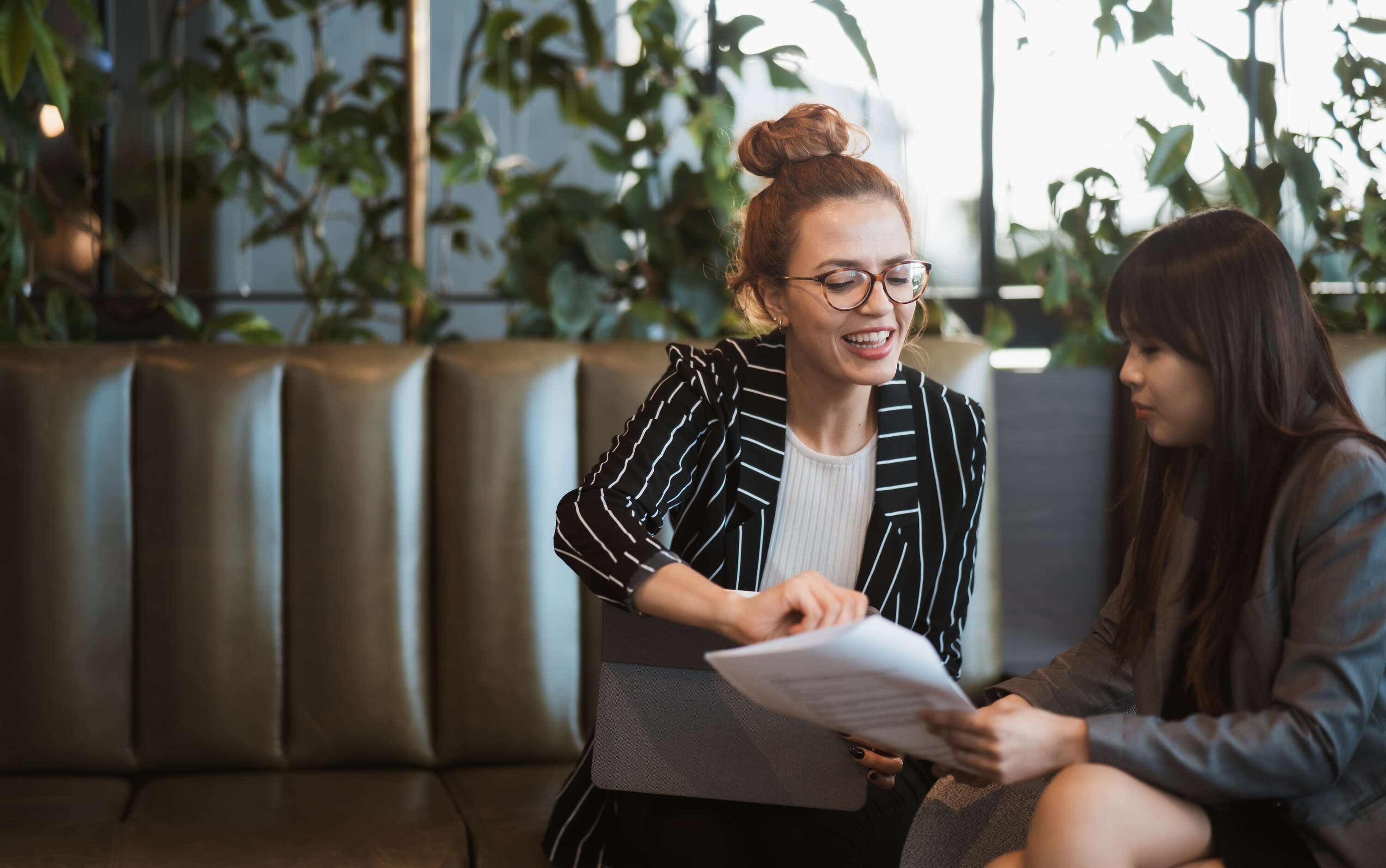 women-on-couch-discussing-work