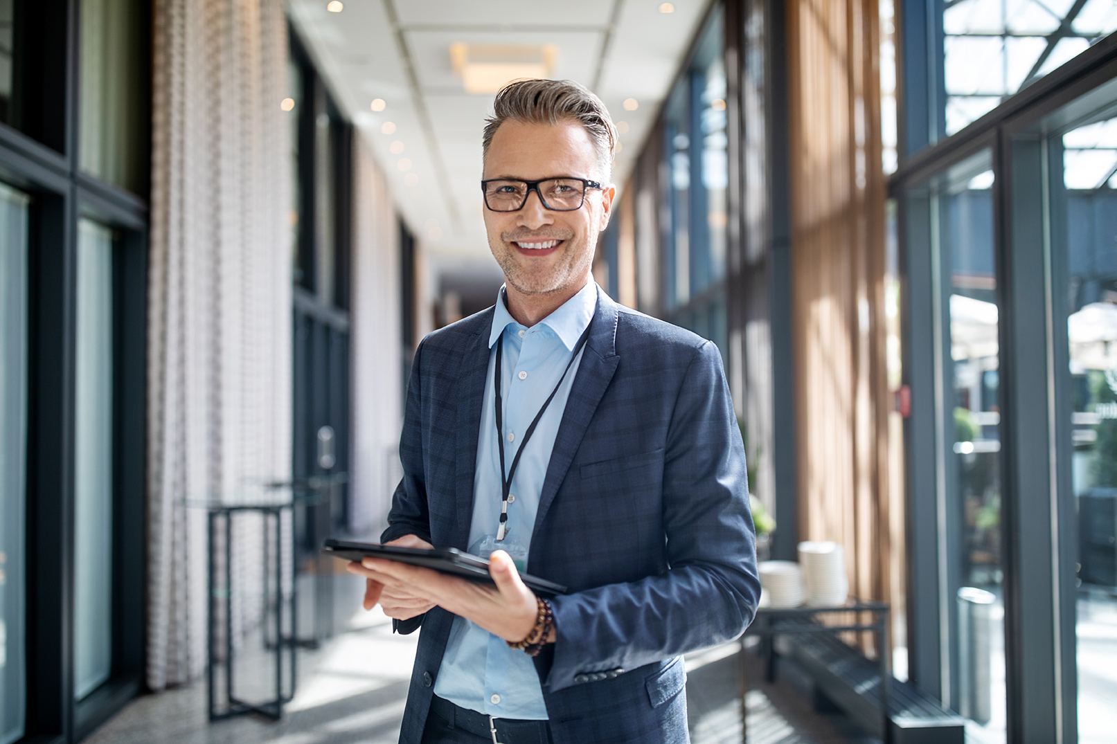 businessman with glasses holding a tablet