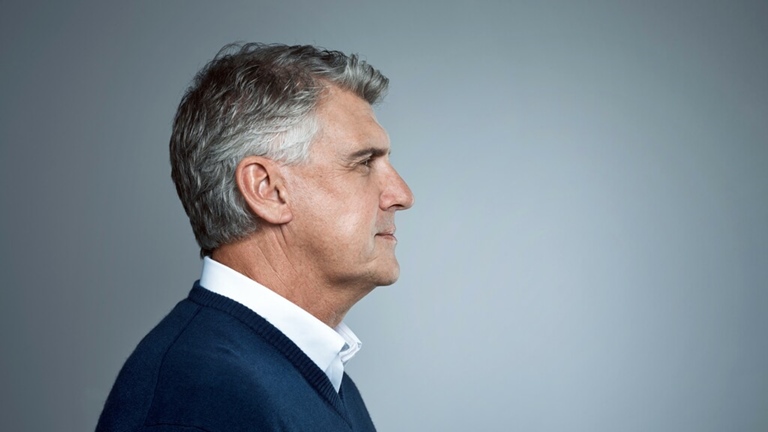 man-senior-looking-forward-grey-background