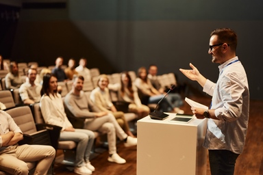 man with glasses giving a lecture
