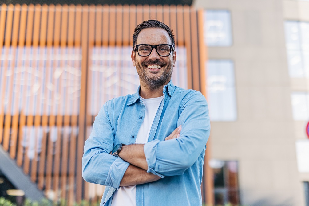 man with watch and glasses crossed arms