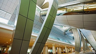 Inside an airport with curved columns and futuristic feel