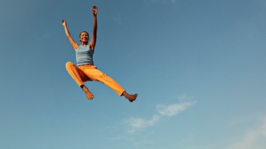 Person jumping blue sky