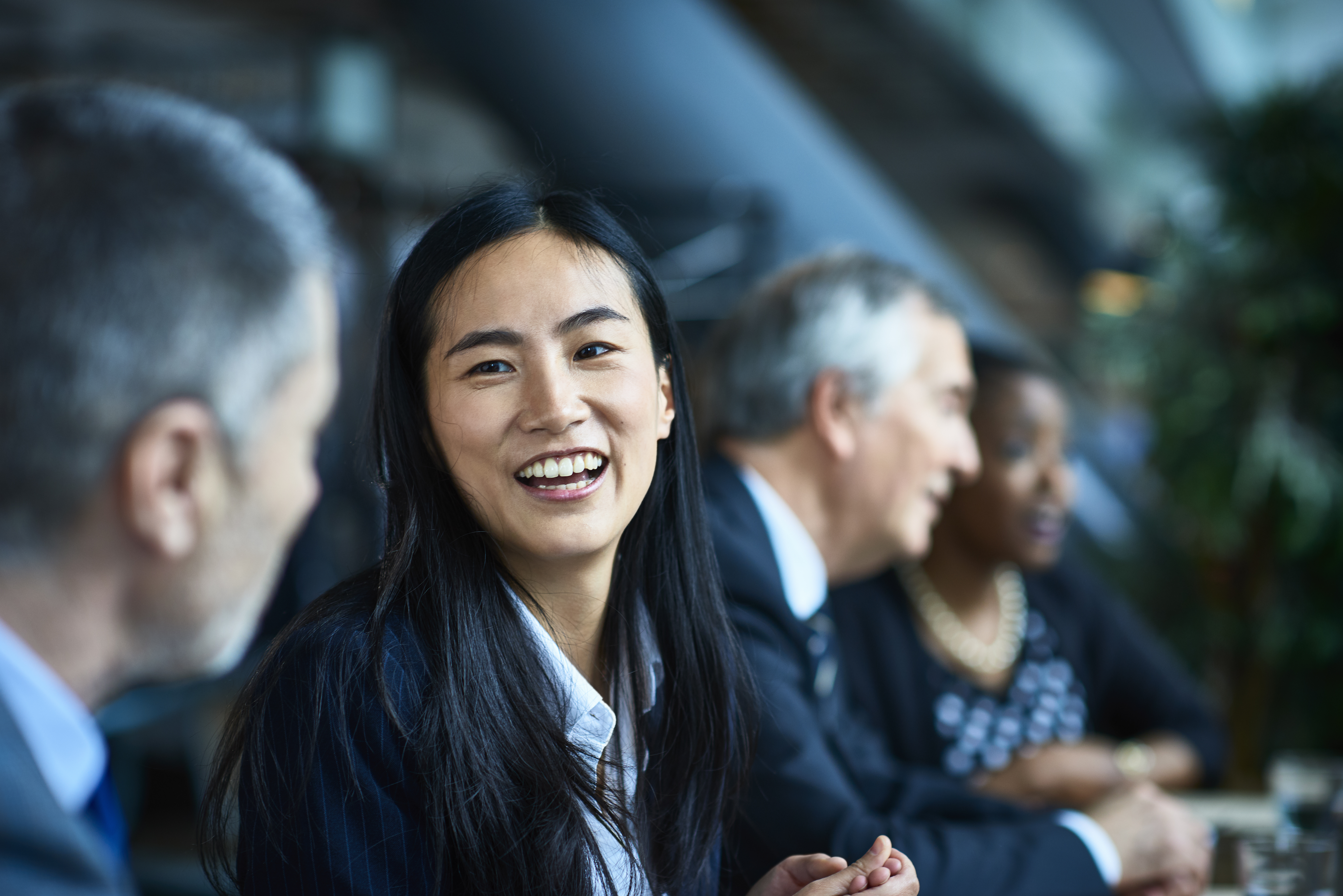 Smiling woman with colleagues