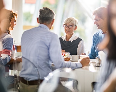 People having a meeting with food and coffee
