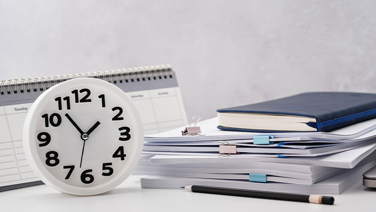 Desk with clock pencil and documents