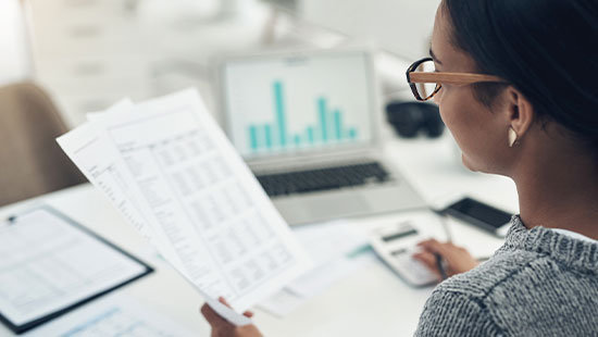 Person reading reports at desk