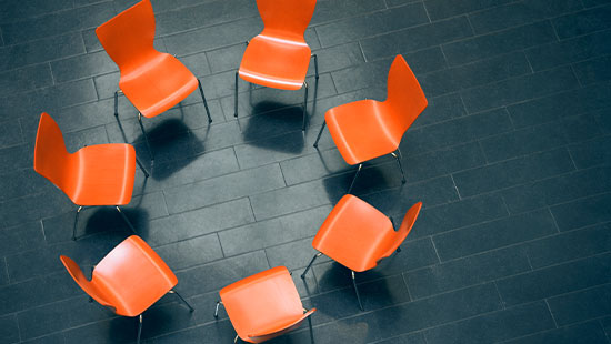 Empty orange chairs circle