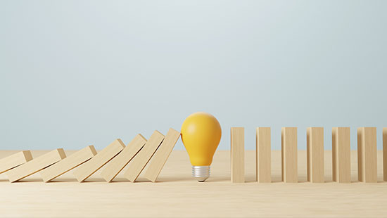 Wooden blocks falling yellow bulb stopping