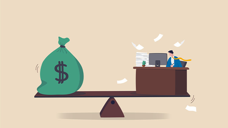Illustration of a person working at a desk on one end of a seesaw, balanced against a large money bag marked with a dollar symbol on the other end. Papers float around the desk, with a small plant and computer visible.