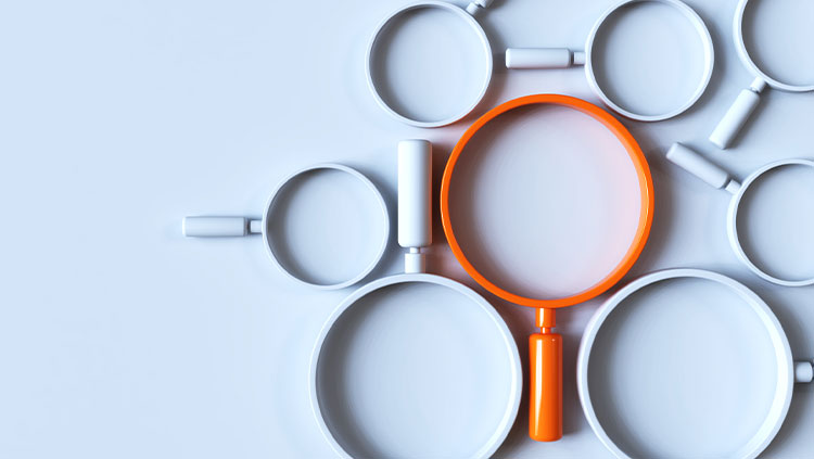 Multiple magnifying glasses one orange