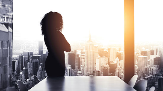 Person standing looking out high rise window