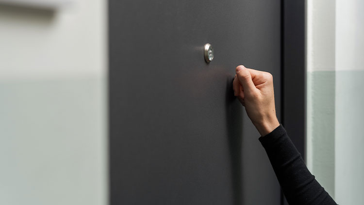 Hand knocking on door