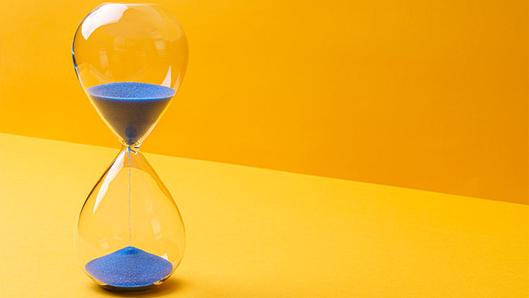 Hour glass counting down yellow background