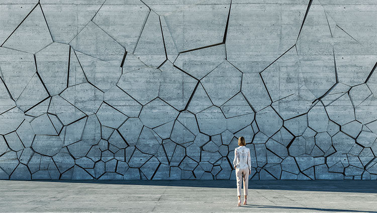 Person looking at cracked concrete wall