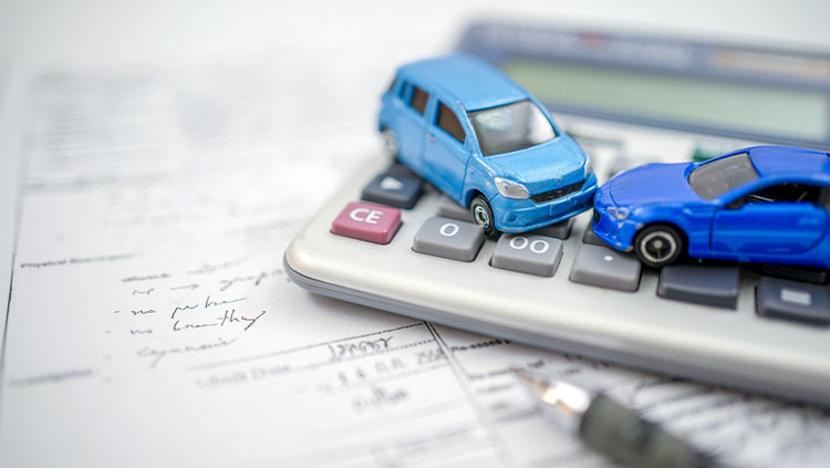 Two toy cars with calculator and papers