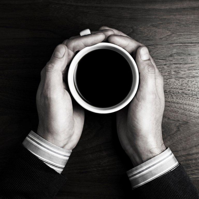 Hands holding coffee cup