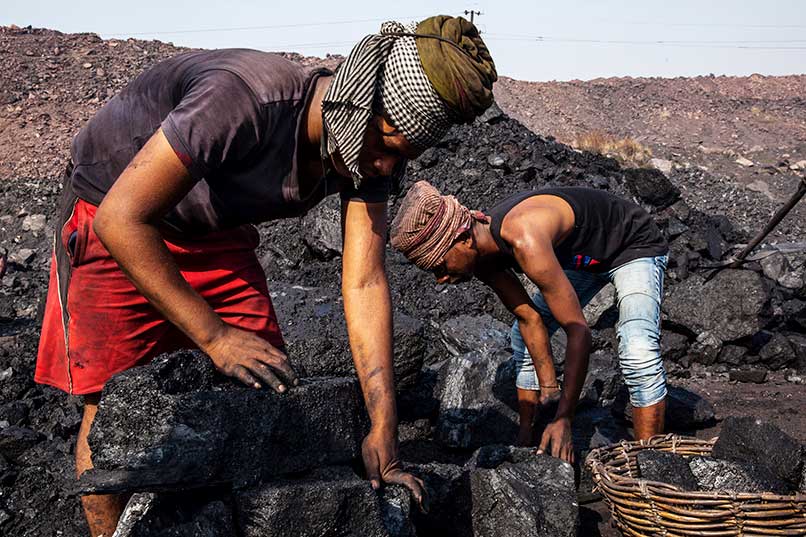 Labours load coal by hand at India’s Bestacolla