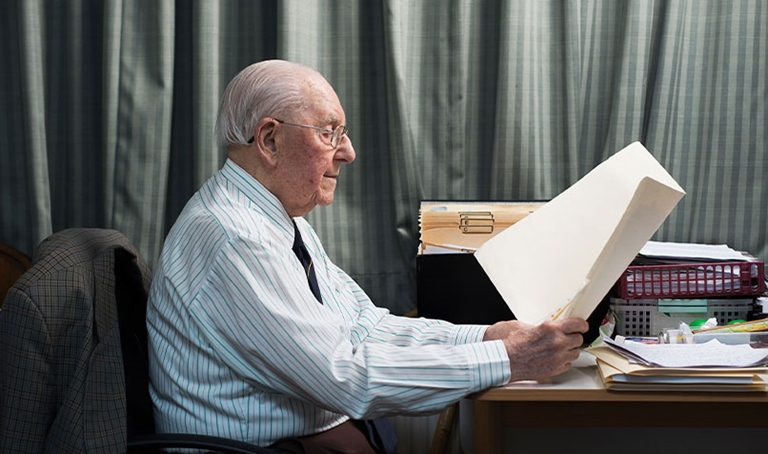 Allan Lorraine sitting at desk