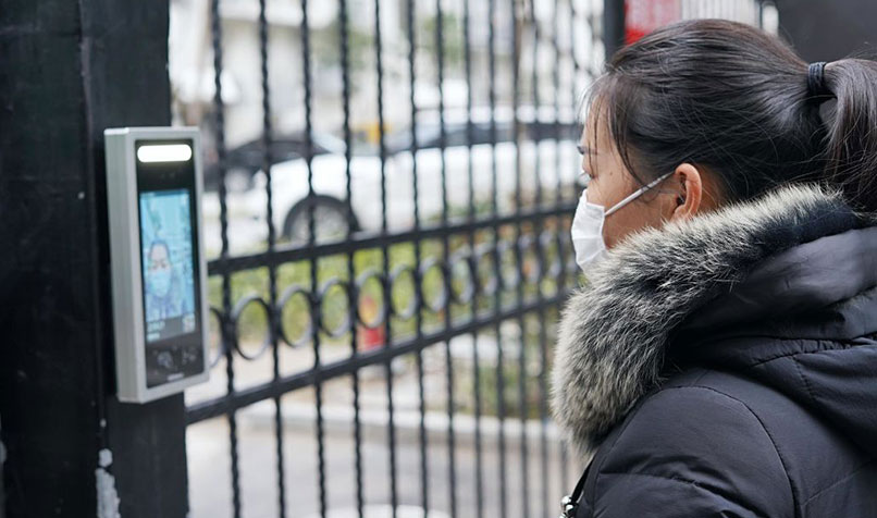 person with facemask using facial recognition