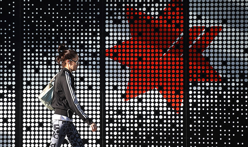 NAB logo person walking past