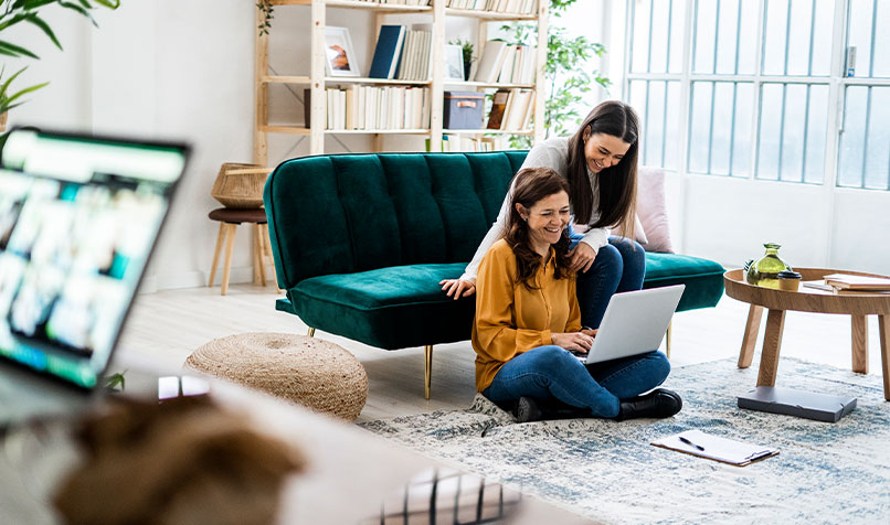 Two women looking laptop