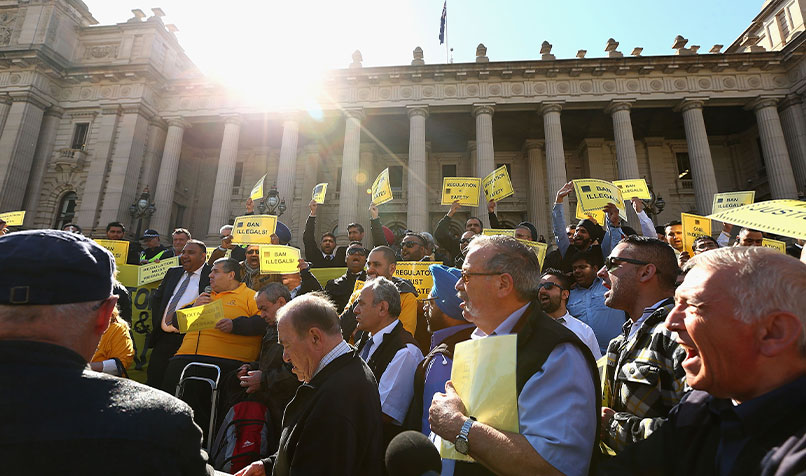 Group of people protesting outside Victorian State Parliament building