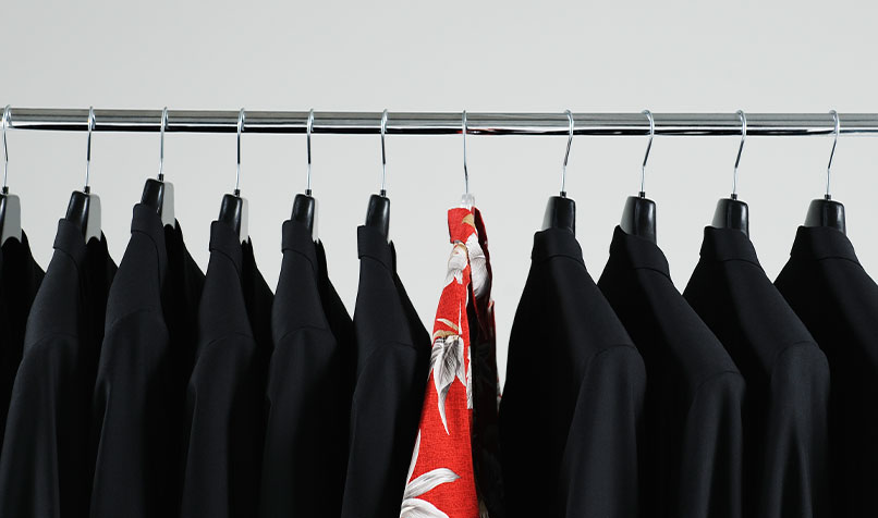 Suits hanging tropical shirt in middle