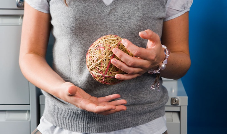 Women holding ball of rubber bands