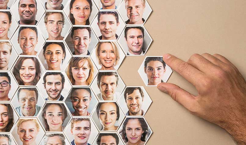 Tiles of people with one being chosen by a hand