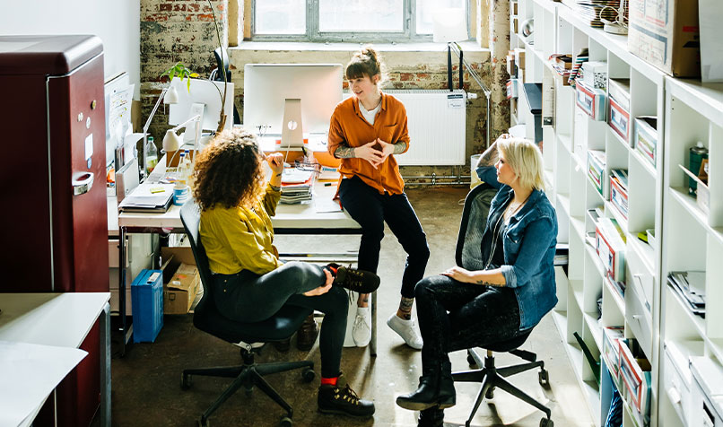 Three women talking at work