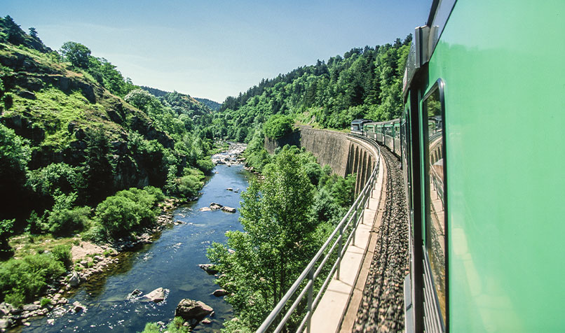 Train travelling along river France