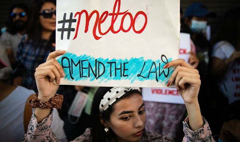 Women holding sign amend the laws