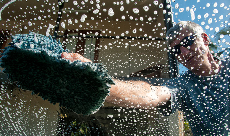 Person cleaning car window