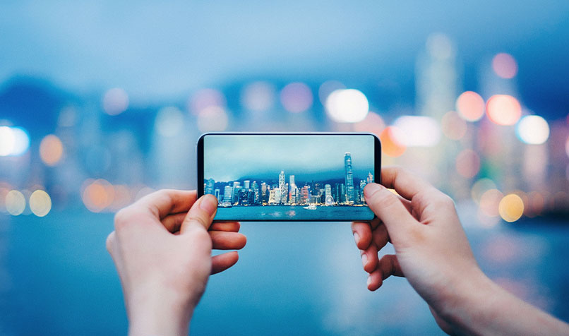 Person holding phone taking photo