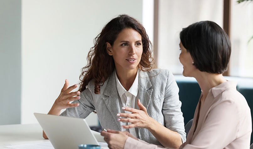 Two people talking meeting workplace