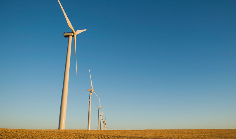 Wind turbines paddock blue sky