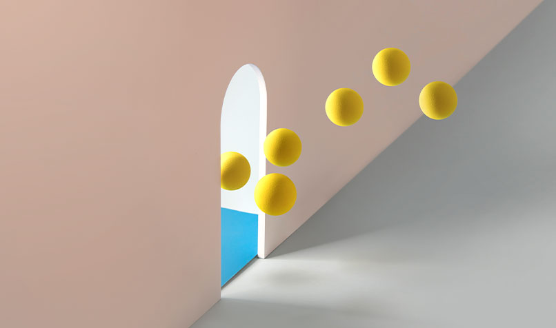 Yellow balls floating out hole wall