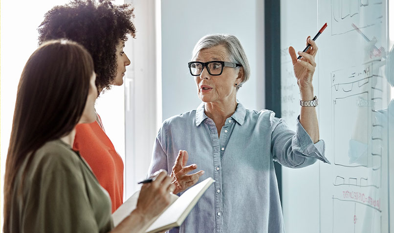 Older women talking to younger workers