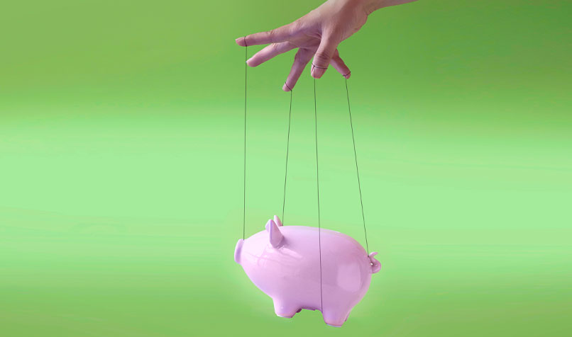 Piggy bank strings being controlled by a hand