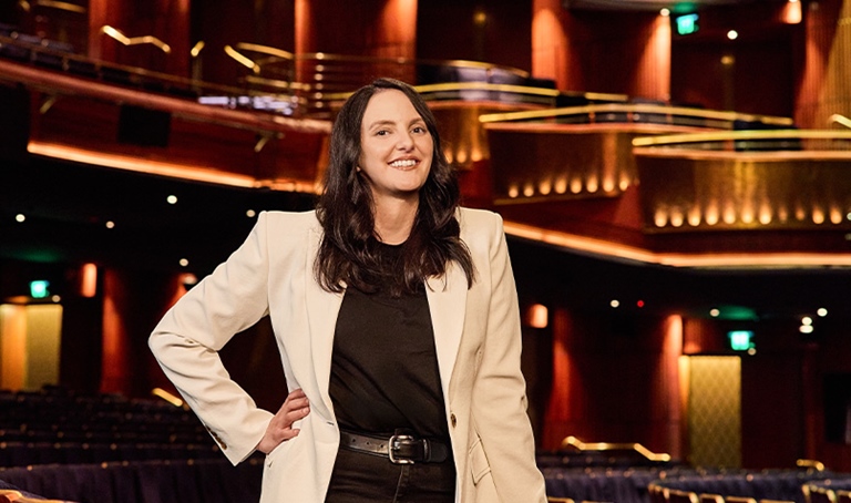 Nicole Marcusson standing in stalls in a theatre