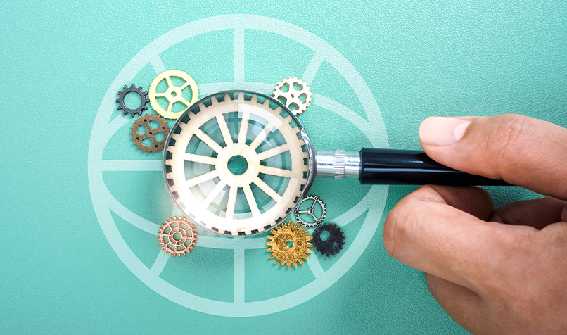 Magnifying glass in hand with many cogwheels, blue background with digital earth icon.