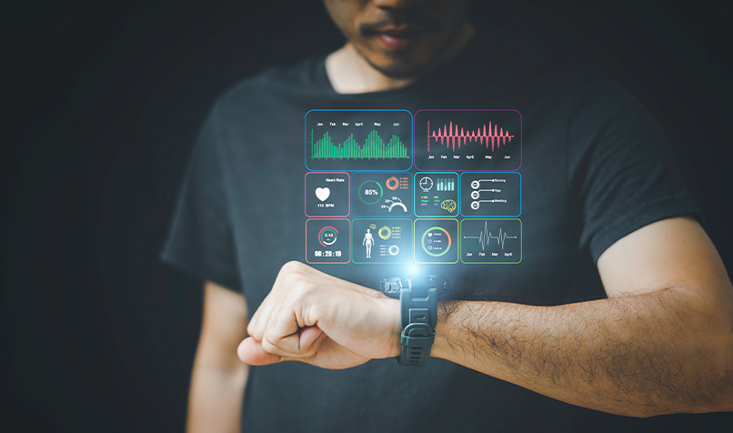 Close-up of a person wearing a smartwatch and viewing fitness tracking metrics, including charts and health monitoring data shown as a digital interface.