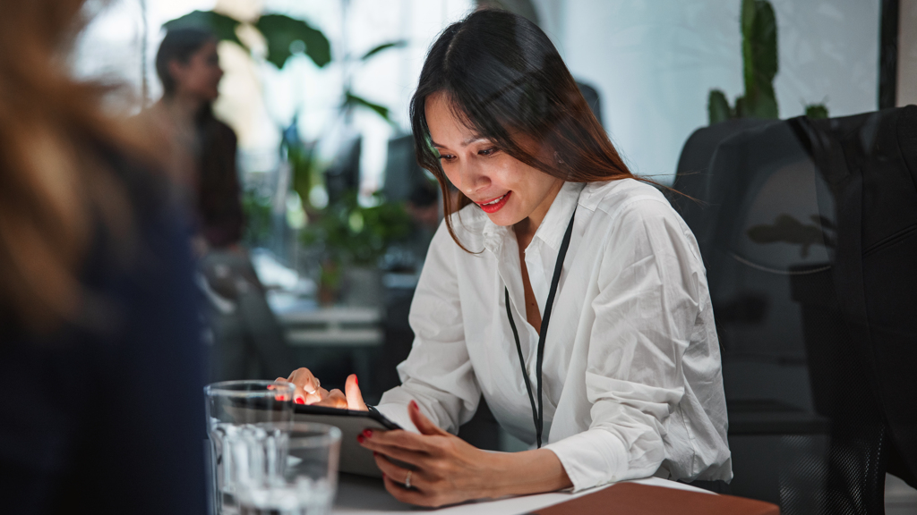 Asian-woman-sitting-using-tablet