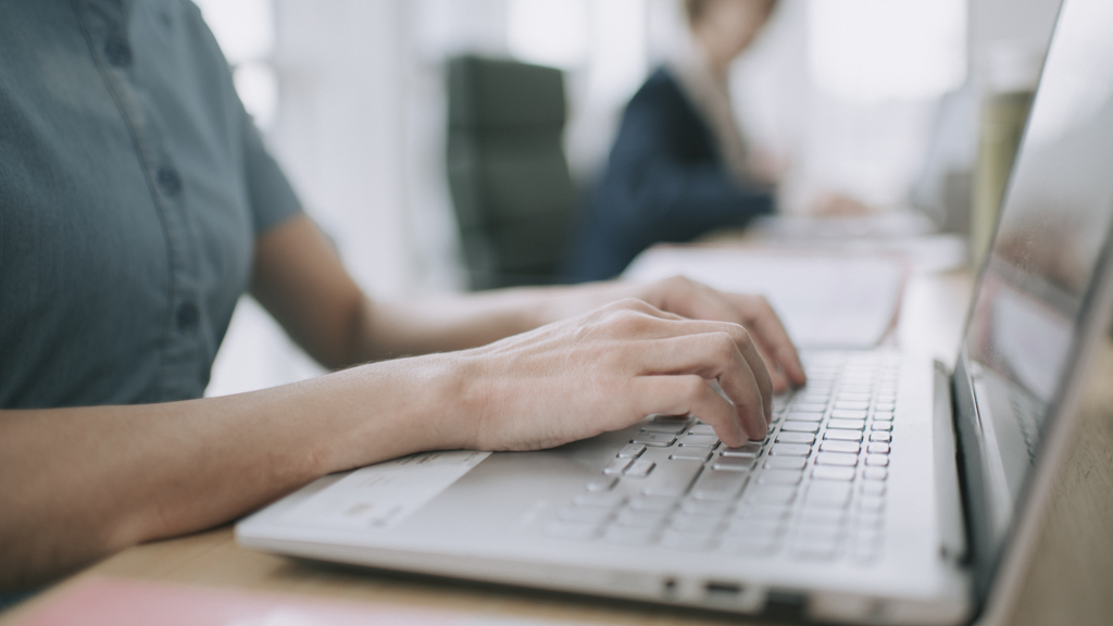 Colleagues-typing-on-laptop-working